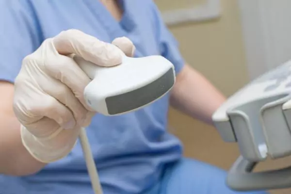 Woman holding ultrasound machine