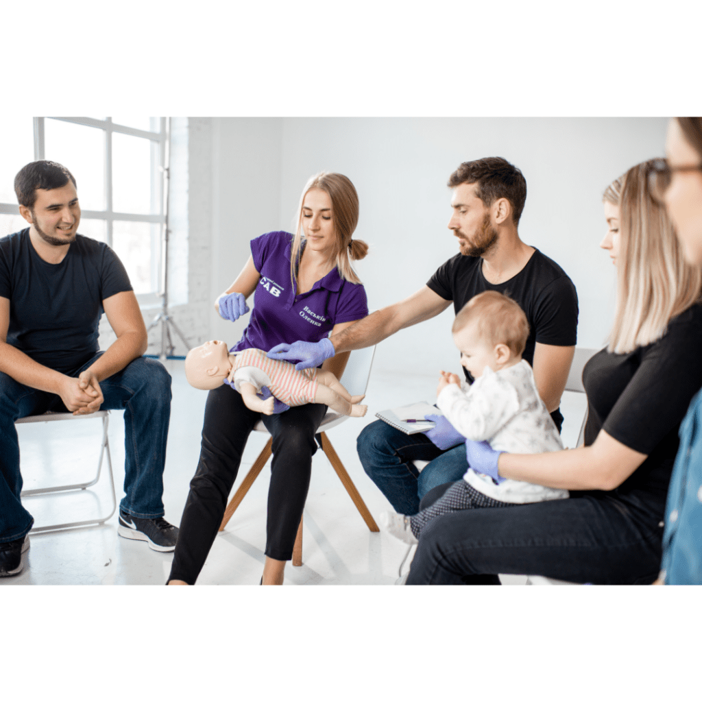 Certified CPR Trainer teaching new parents cpr on baby.